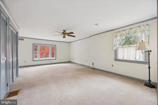 a view of a livingroom with a ceiling fan and window
