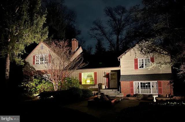 an aerial view of a house with a yard and large tree
