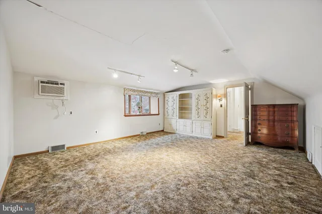 a bathroom with a toilet a sink a vanity and mirror