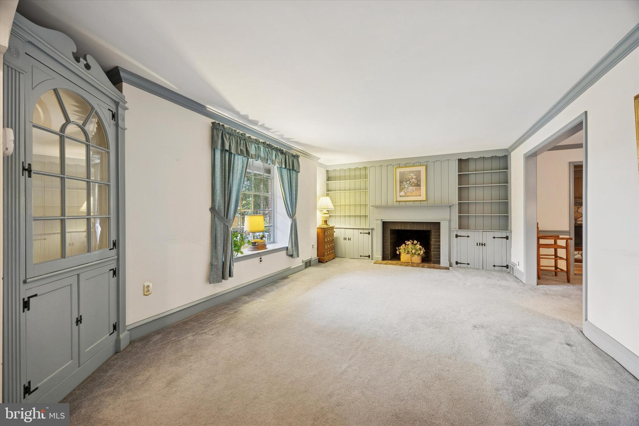 1162 Limekiln Pike Ambler, PA 19002 - Photo 9 of 56 a view of an empty room with a fireplace and a window