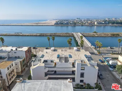 an aerial view of a house with outdoor seating