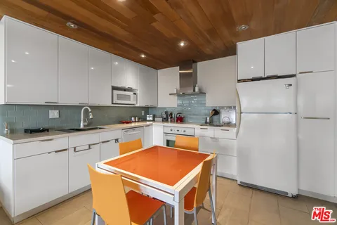 a kitchen with stainless steel appliances granite countertop a refrigerator sink stove and microwave