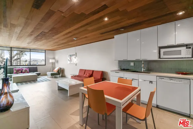a kitchen with a table chairs sink and cabinets