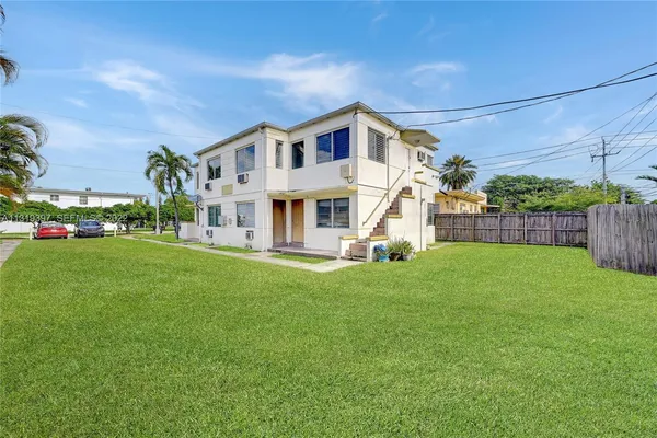 a view of a house with a yard