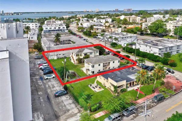an aerial view of multiple houses with yard