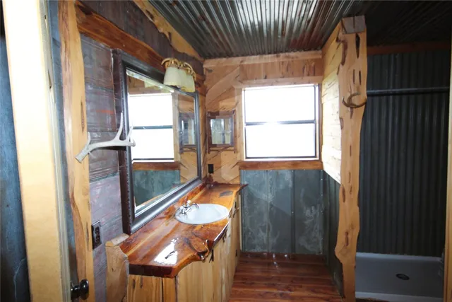 a view of a porch with wooden floor and furniture