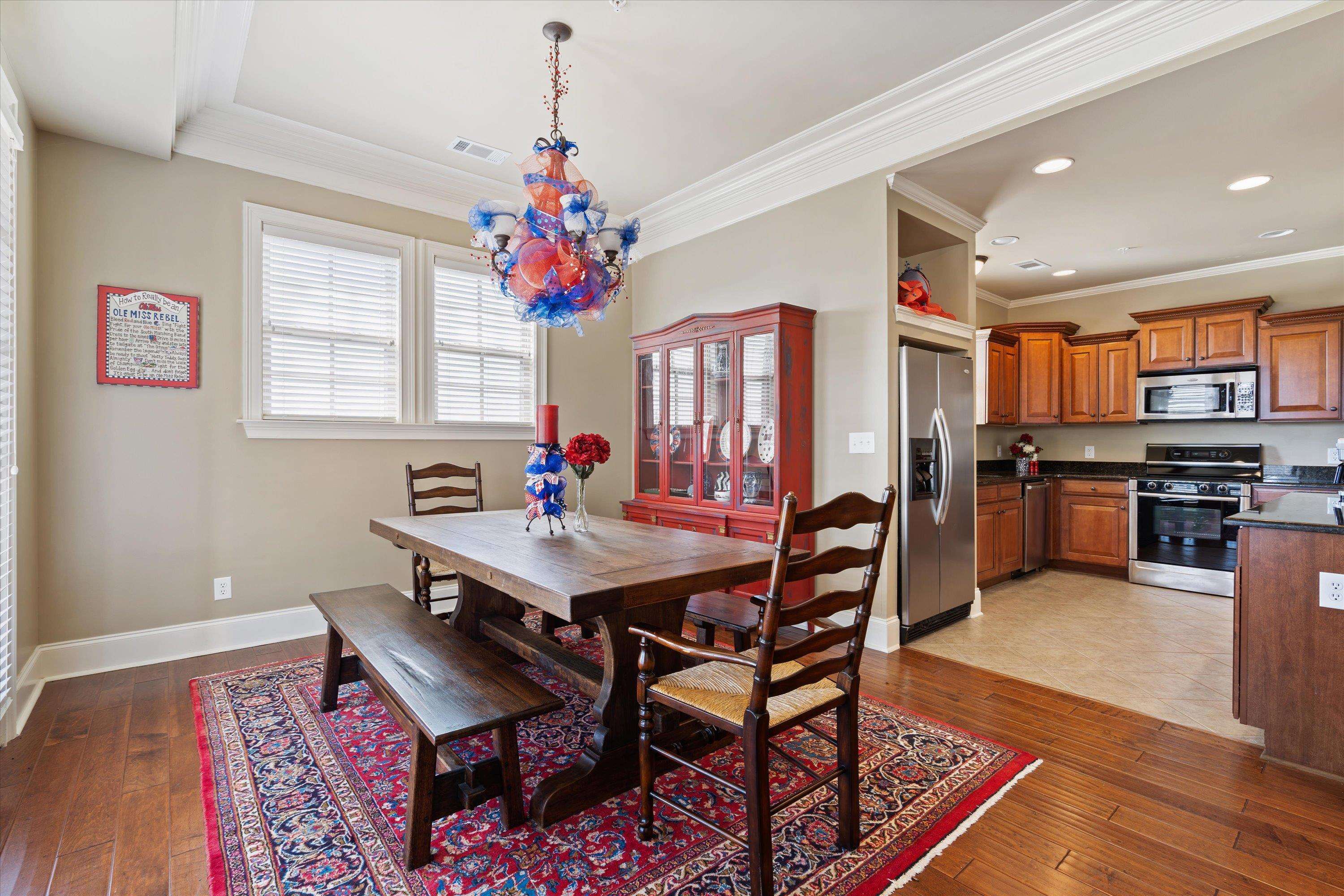 1100 Augusta Drive, Unit 103 Oxford, MS 38655 - Photo 11 of 24 a view of a dining room with furniture and window