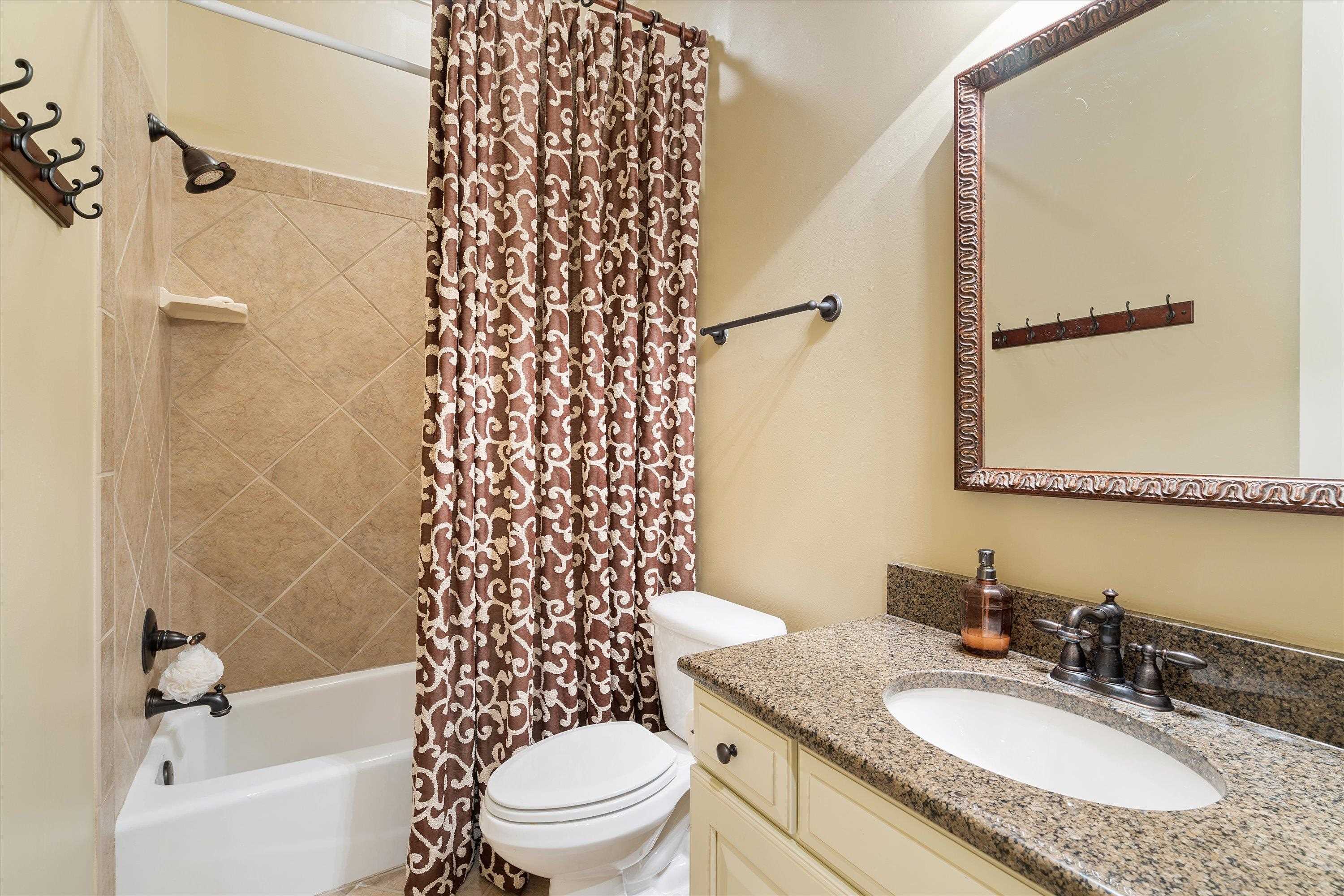 1100 Augusta Drive, Unit 103 Oxford, MS 38655 - Photo 16 of 24 a bathroom with a granite countertop sink toilet a mirror and shower