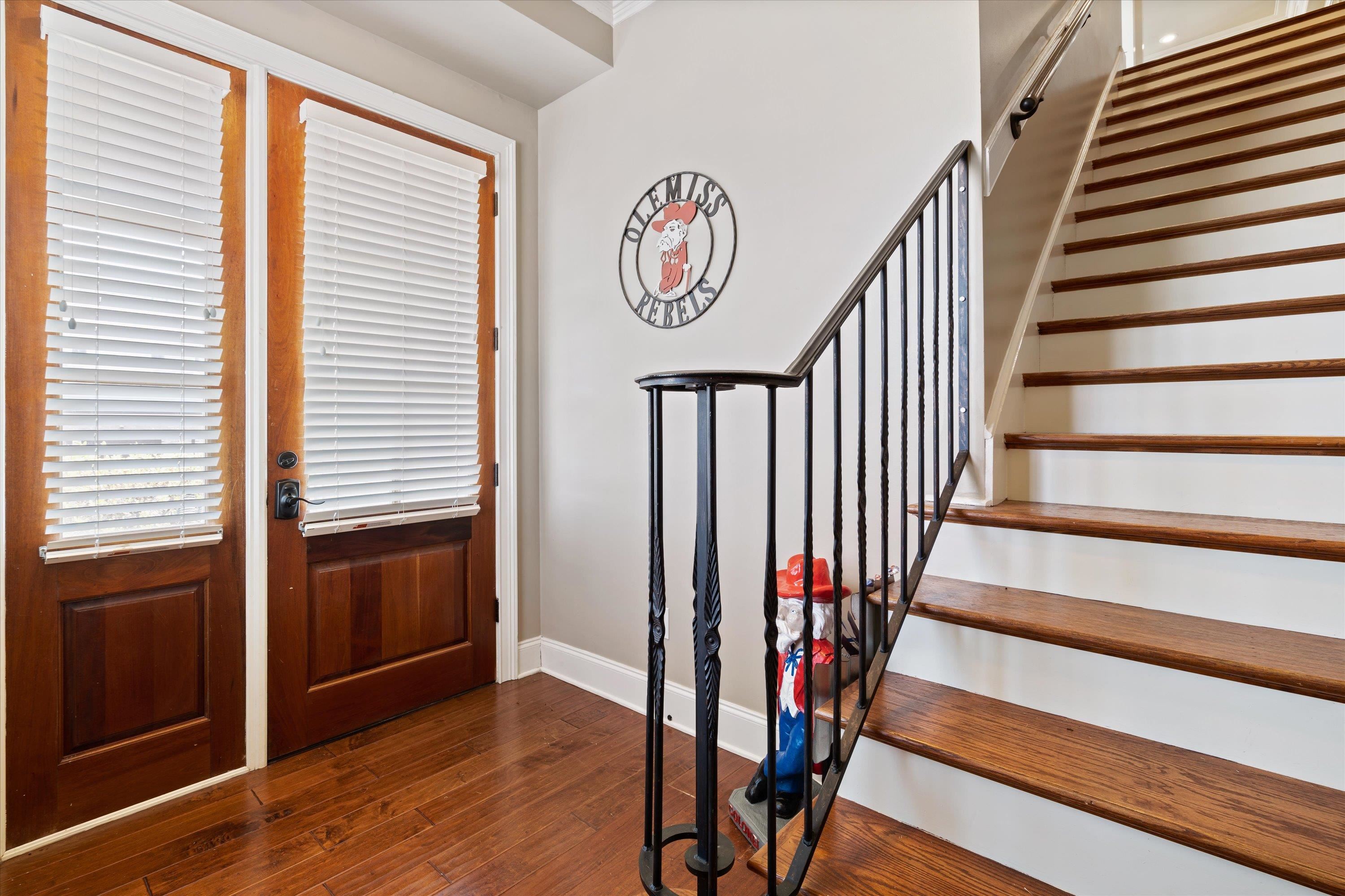 1100 Augusta Drive, Unit 103 Oxford, MS 38655 - Photo 4 of 24 a view of entryway with wooden floor and stairs