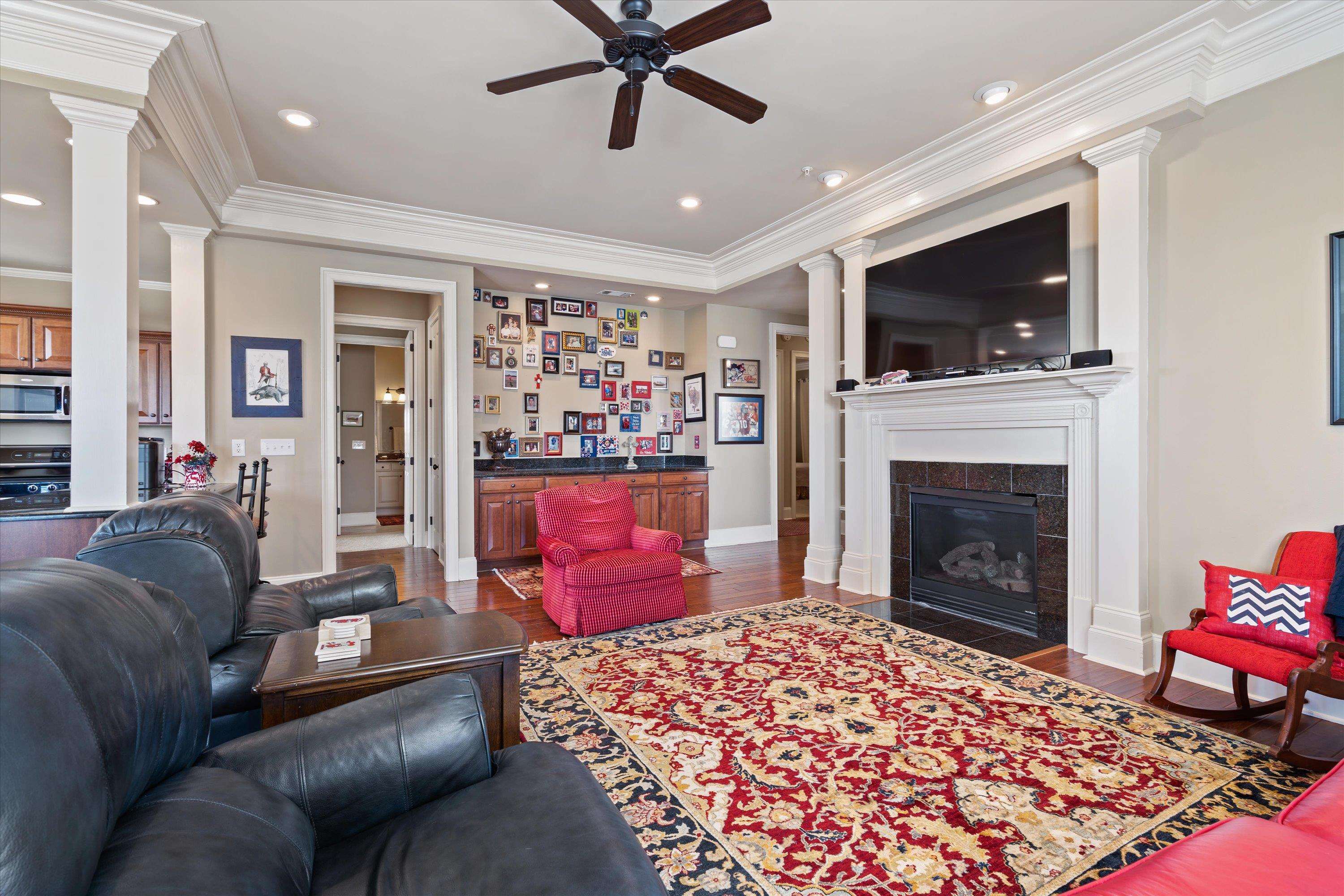 1100 Augusta Drive, Unit 103 Oxford, MS 38655 - Photo 6 of 24 a living room with furniture a flat screen tv and a fireplace