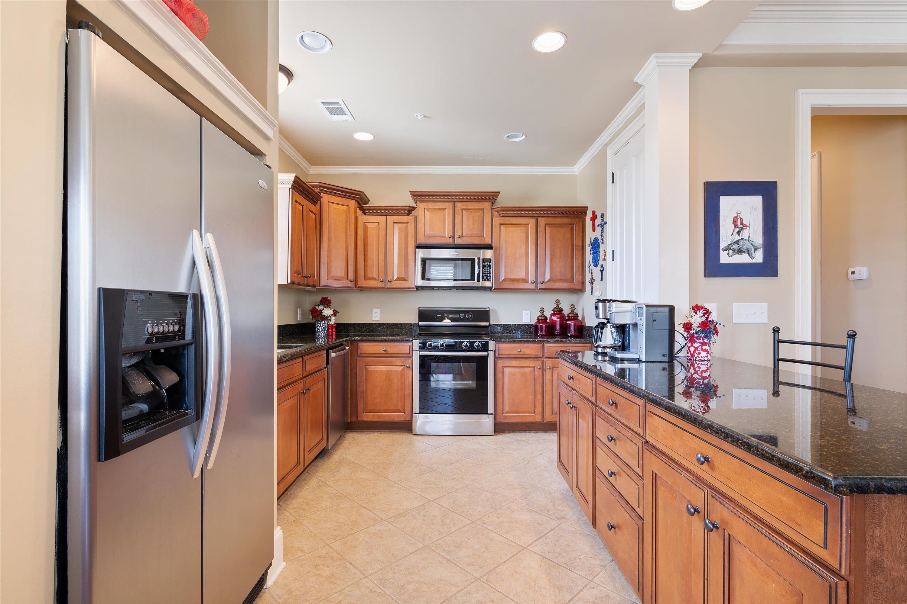 1100 Augusta Drive, Unit 103 Oxford, MS 38655 - Photo 7 of 24 a kitchen with stainless steel appliances granite countertop a refrigerator a stove a sink and a microwave