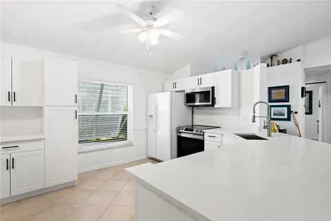 a kitchen with stainless steel appliances a stove refrigerator sink and microwave