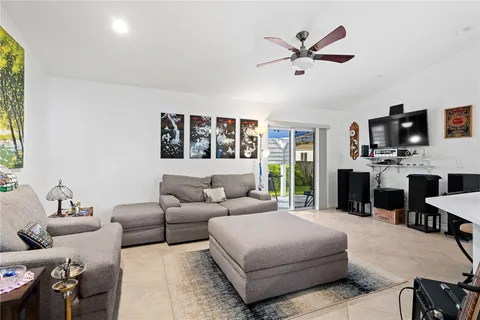a living room with furniture a fireplace and a window