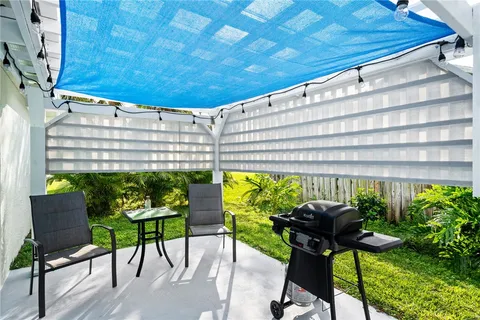 a balcony with table and chairs