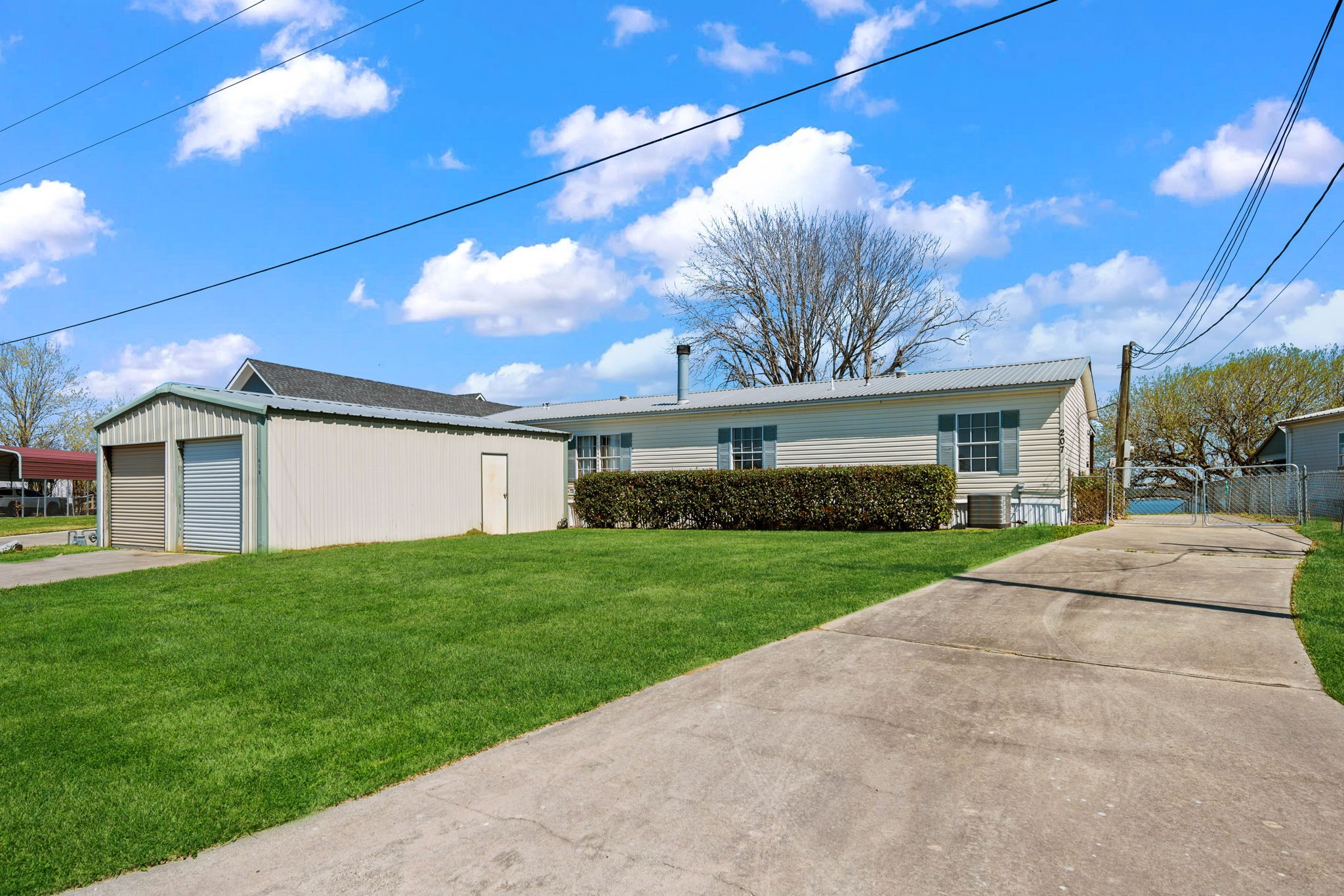 207 Vivian Road Onalaska, TX 77360 - Photo 12 of 33 Front of home with detached 2 car garage/workshop. Two driveways for extra parking.