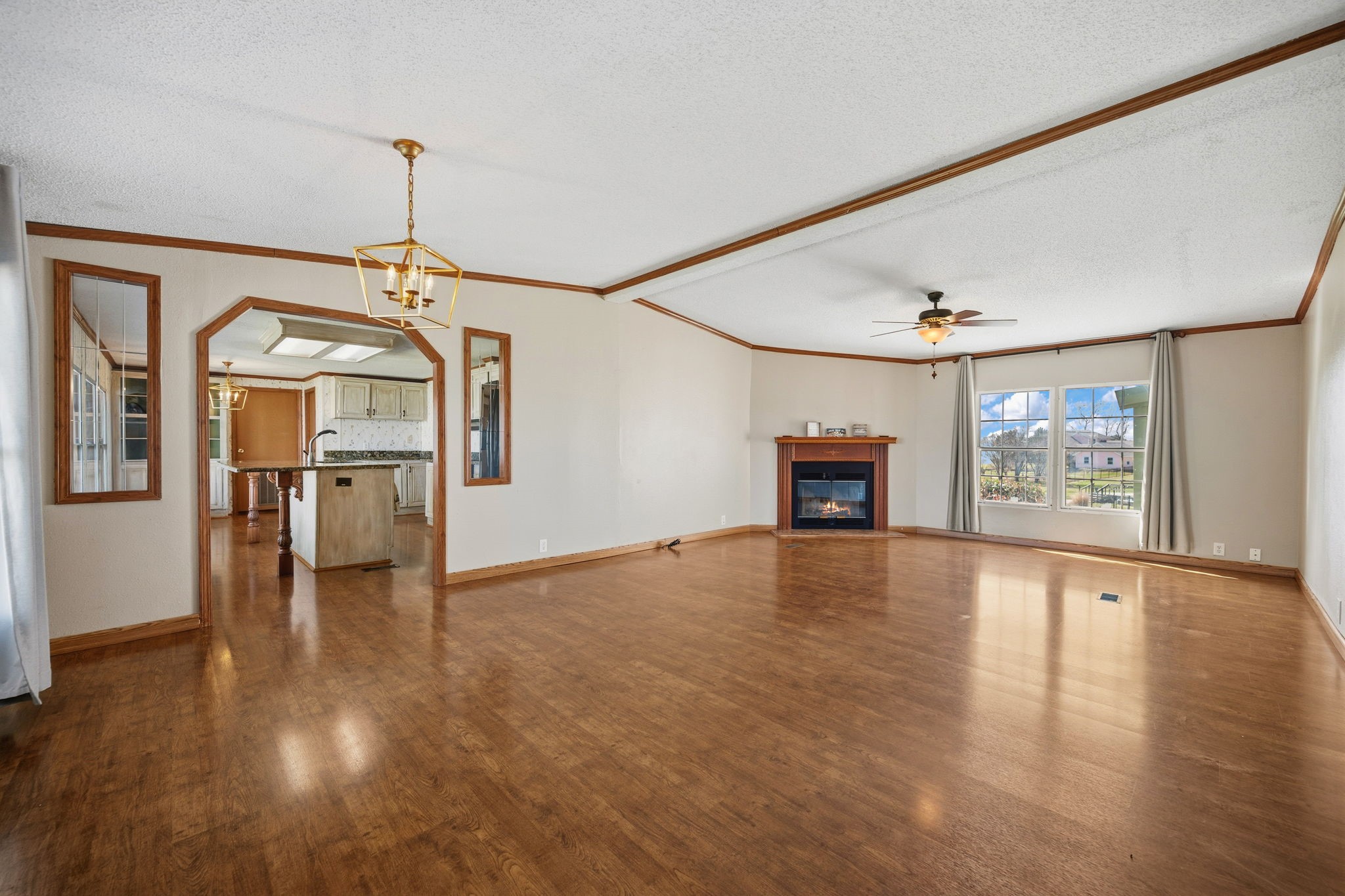 207 Vivian Road Onalaska, TX 77360 - Photo 14 of 33 Spacious living/dining. This photo is taken from the dining area. Wood burning fireplace, laminate flooring and large windows.