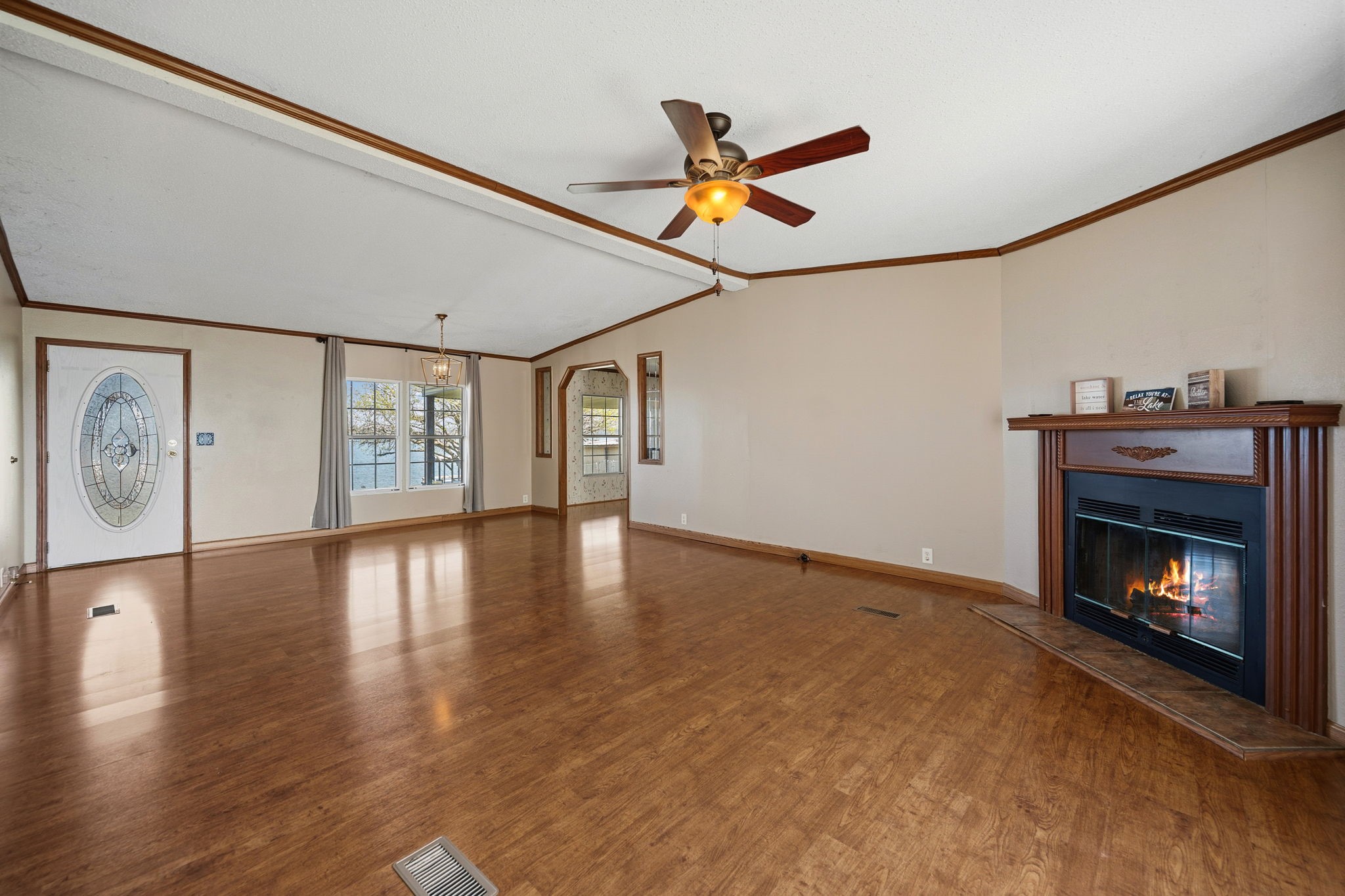 207 Vivian Road Onalaska, TX 77360 - Photo 16 of 33 a view of an empty room with a fireplace and a window
