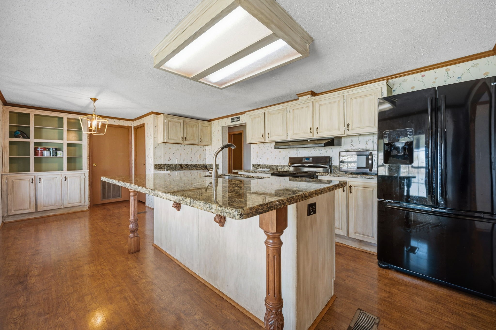 207 Vivian Road Onalaska, TX 77360 - Photo 19 of 33 a kitchen with stainless steel appliances granite countertop a refrigerator a stove and a sink with wooden floor