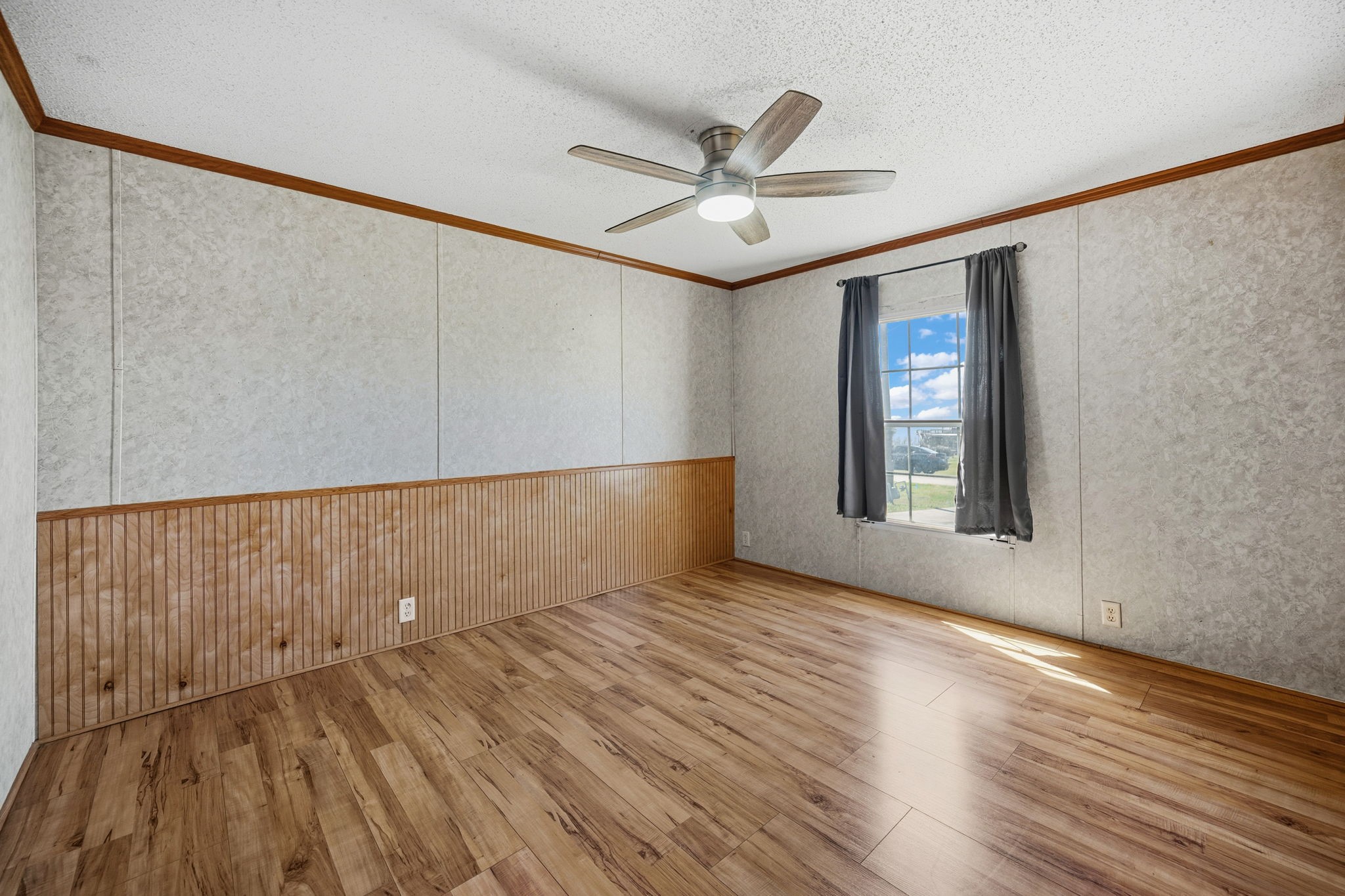207 Vivian Road Onalaska, TX 77360 - Photo 23 of 33 an empty room with wooden floor fan and windows