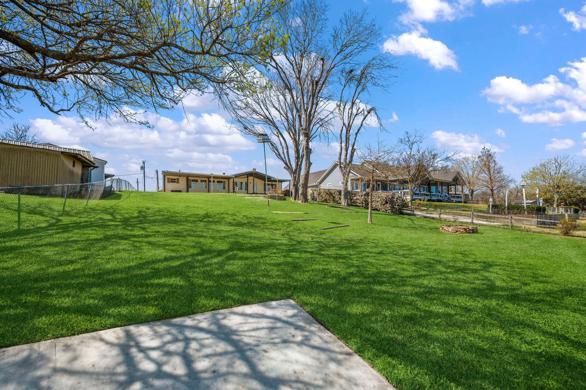 207 Vivian Road Onalaska, TX 77360 - Photo 10 of 33 From the sitting area down by the water looking back toward the home. The covered back porch spans the entire length of the home.