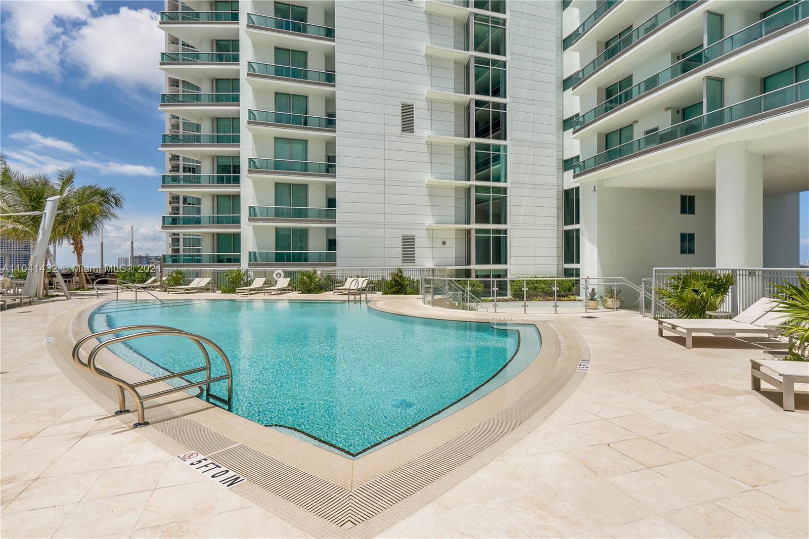900 Biscayne Boulevard, Unit 6301 Miami, FL 33132 - Photo 11 of 72 a swimming pool with outdoor seating and yard