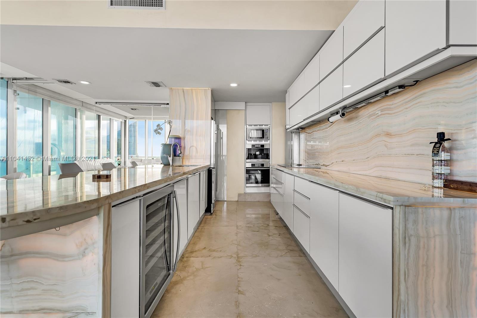 900 Biscayne Boulevard, Unit 6301 Miami, FL 33132 - Photo 39 of 72 a large kitchen with a large counter top and stainless steel appliances