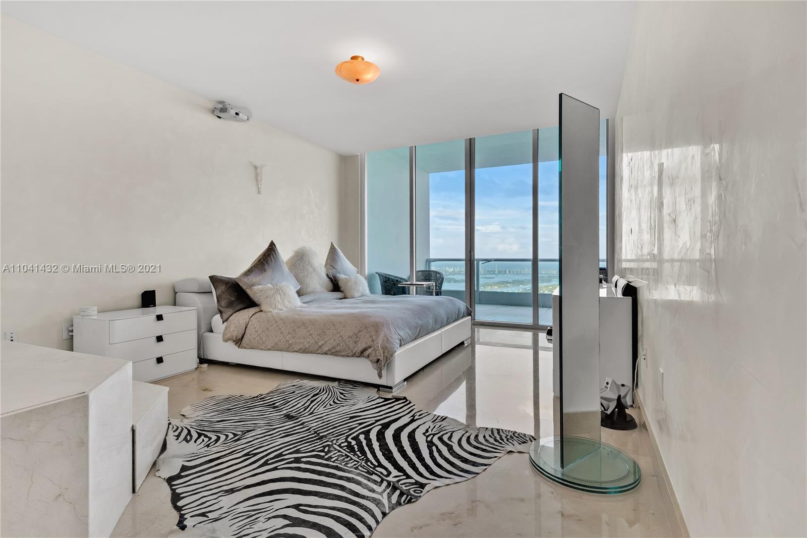 900 Biscayne Boulevard, Unit 6301 Miami, FL 33132 - Photo 43 of 72 a bedroom with a bed and a chandelier