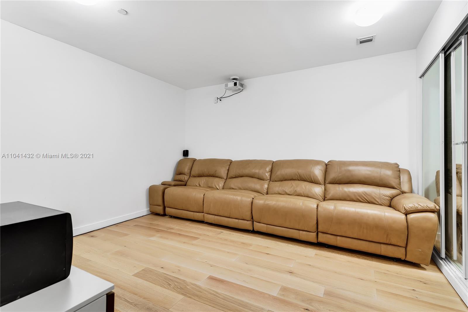 900 Biscayne Boulevard, Unit 6301 Miami, FL 33132 - Photo 51 of 72 a living room with furniture and a wooden floor