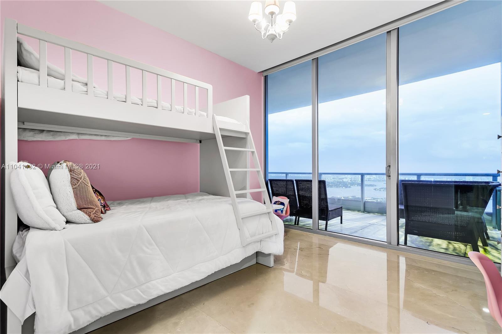 900 Biscayne Boulevard, Unit 6301 Miami, FL 33132 - Photo 57 of 72 a bedroom with a bed and large mirror
