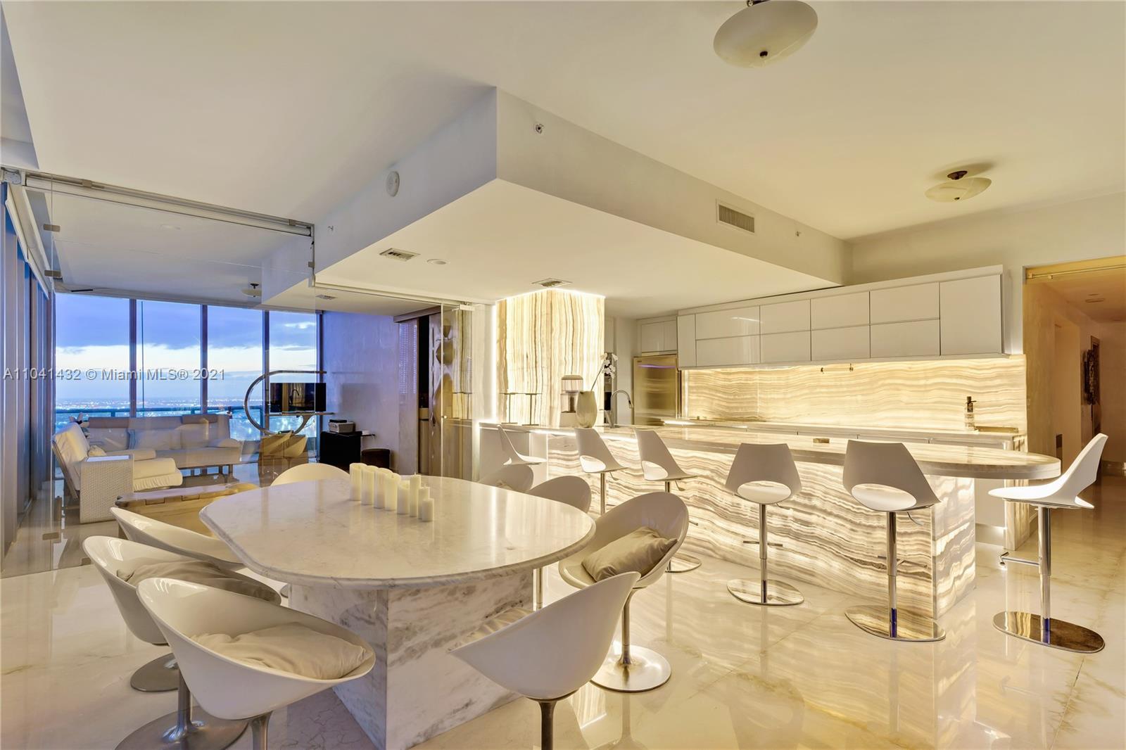 900 Biscayne Boulevard, Unit 6301 Miami, FL 33132 - Photo 60 of 72 a dining room with stainless steel appliances kitchen island granite countertop a table and chairs