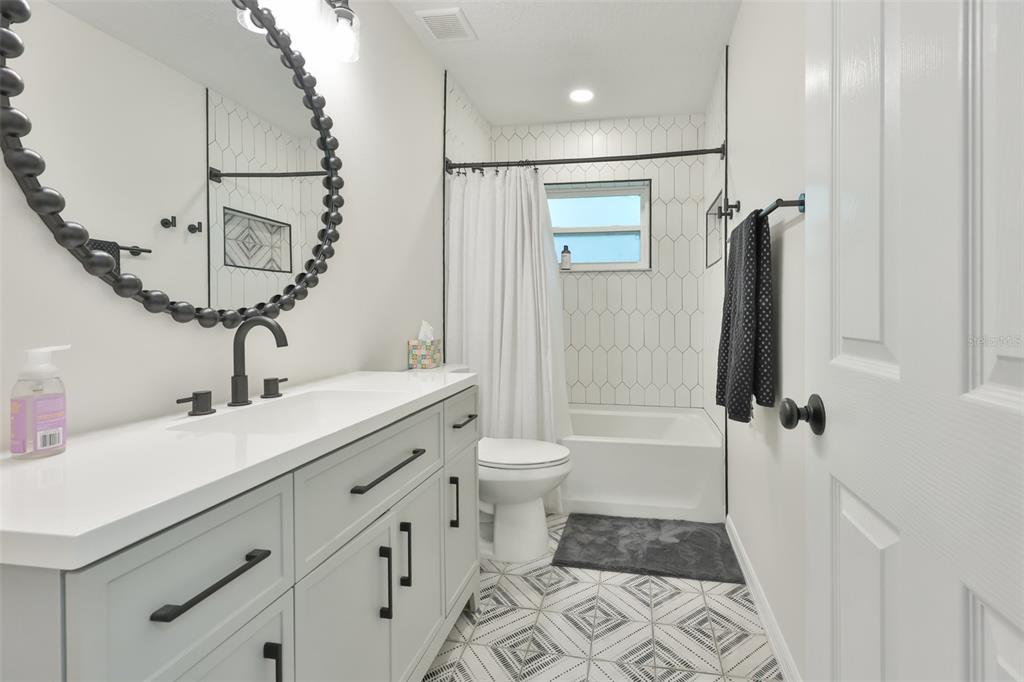 1578 Indian Bay Road Spring Hill, FL 34607 - Photo 35 of 51 a bathroom with a double vanity sink toilet and shower