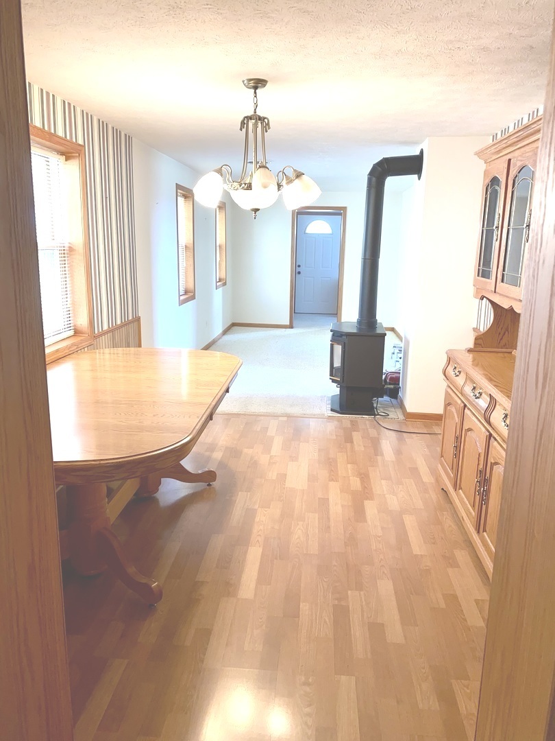 210 South 1st Street Holcomb, IL 61043 - Photo 6 of 15 a view of a kitchen with granite countertop a sink and a fireplace
