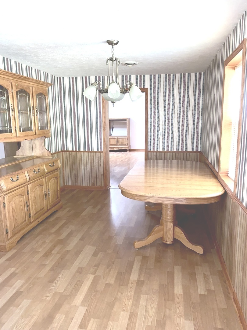 210 South 1st Street Holcomb, IL 61043 - Photo 7 of 15 a view of a livingroom with furniture window and wooden floor