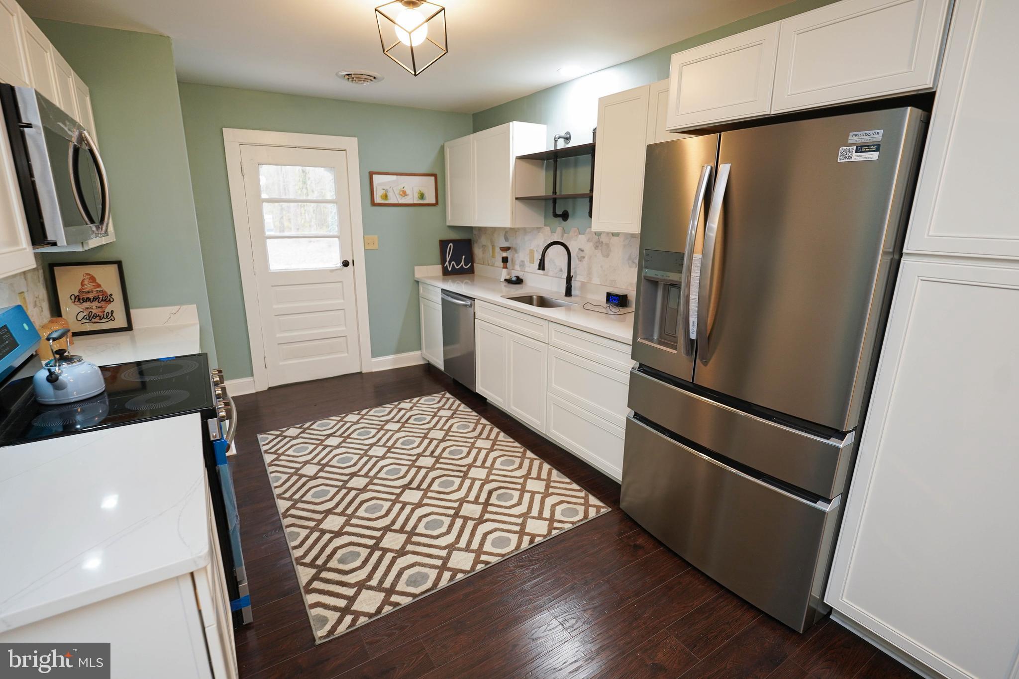 3493 Meadow Bridge Road Eden, MD 21822 - Photo 11 of 36 a kitchen with stainless steel appliances a refrigerator sink and microwave