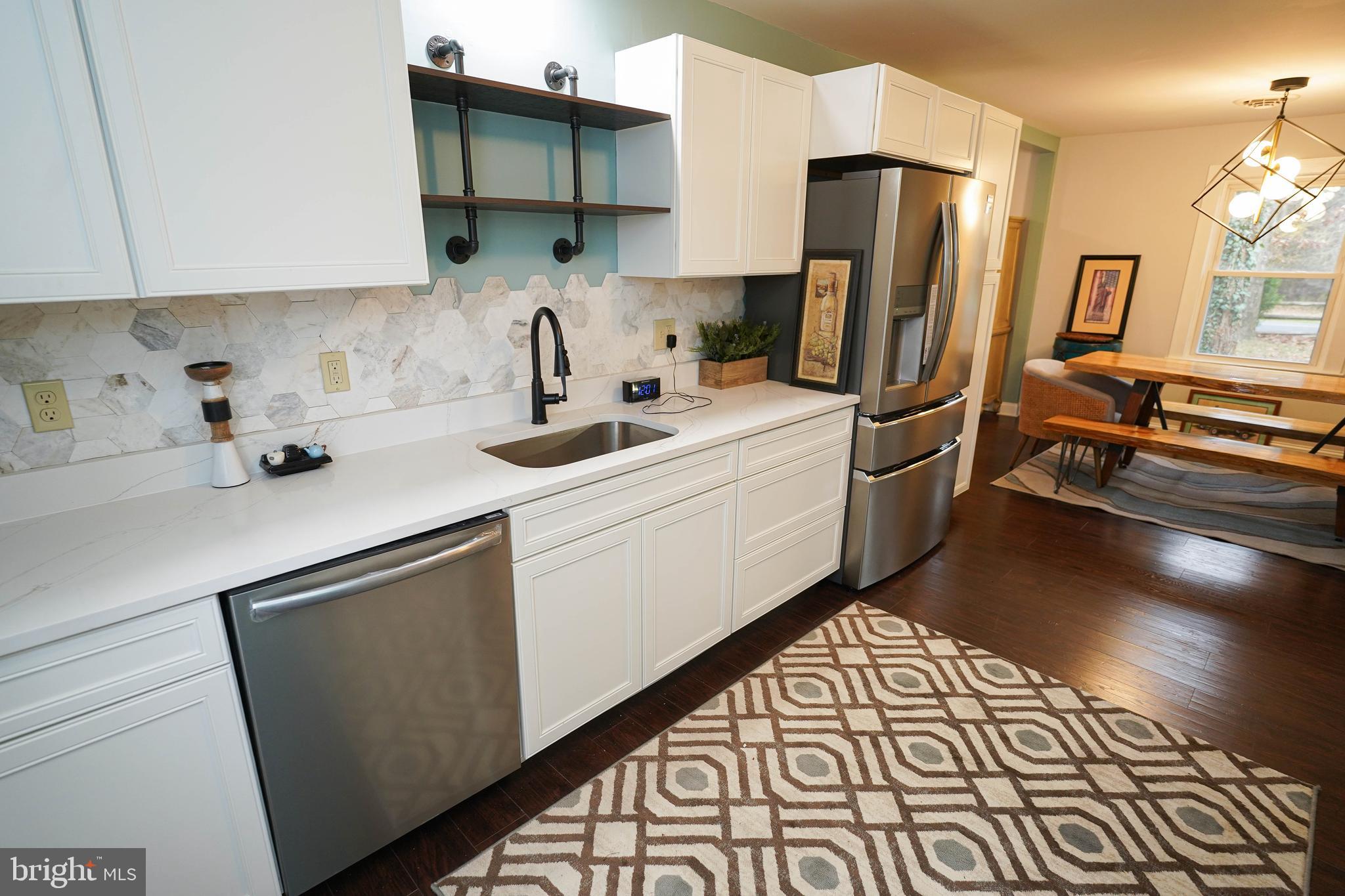 3493 Meadow Bridge Road Eden, MD 21822 - Photo 15 of 36 a kitchen with stainless steel appliances a sink stove refrigerator and cabinets