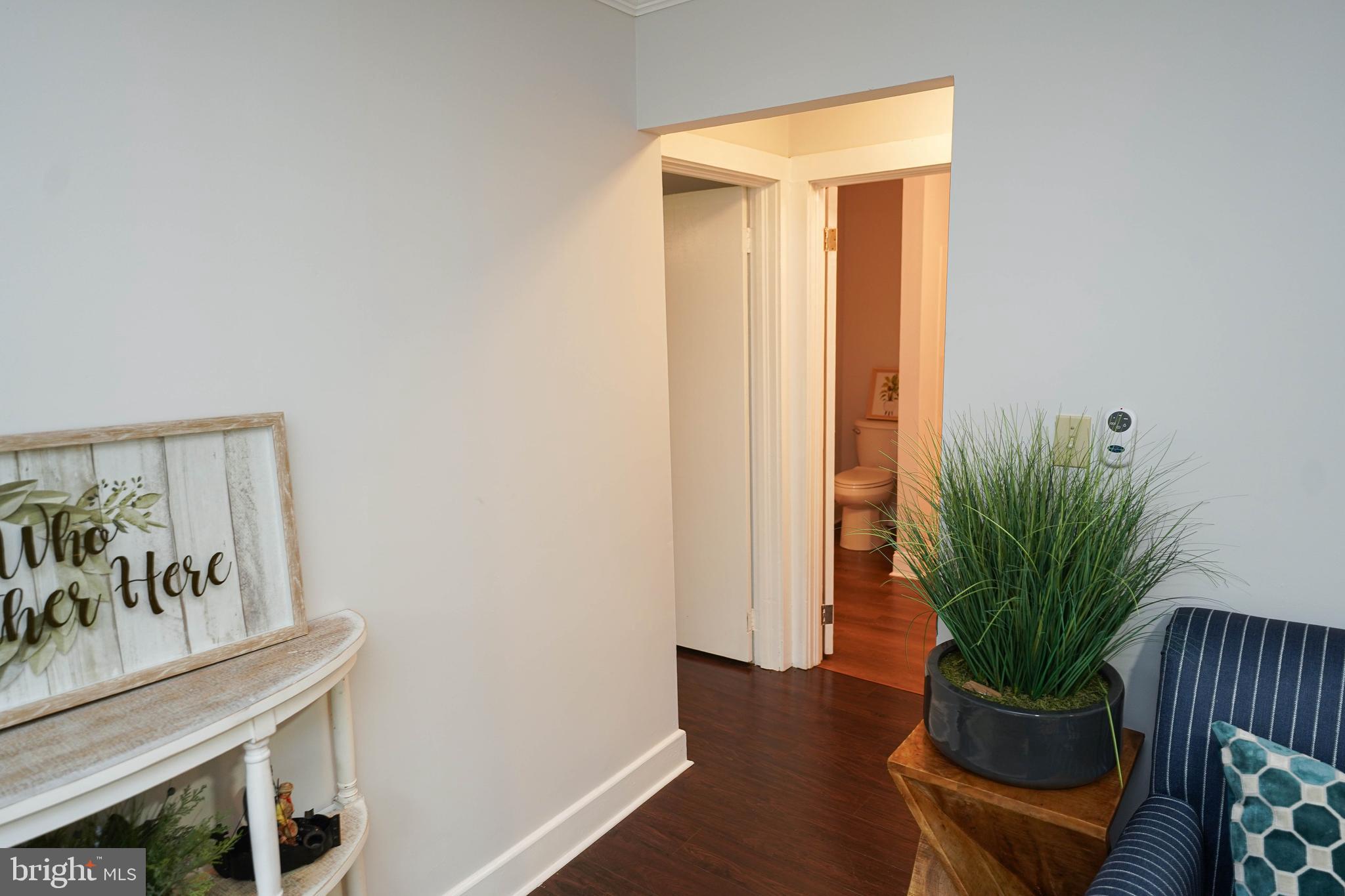 3493 Meadow Bridge Road Eden, MD 21822 - Photo 25 of 36 a view of a hallway with wooden floor and a potted plant