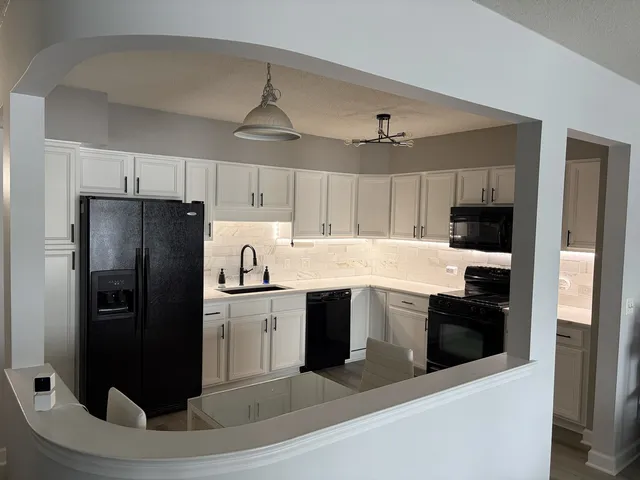 a kitchen with a refrigerator and a sink