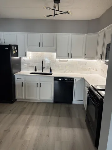 a kitchen with stainless steel appliances granite countertop a sink and a stove