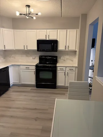 a kitchen with granite countertop a stove and a sink