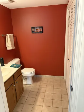 a bathroom with a toilet a sink and a mirror