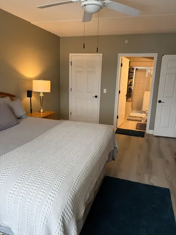 a bedroom with a bed and a mirror