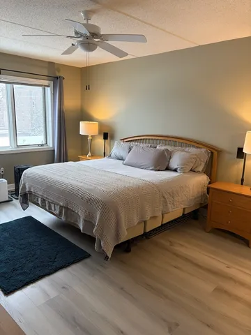 a bedroom with double bed and a window