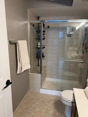 a bathroom with a toilet and shower