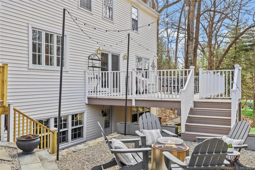 183 Frogtown Road New Canaan, CT 06840 - Photo 29 of 37 a front view of a house with barbeque grill and furniture