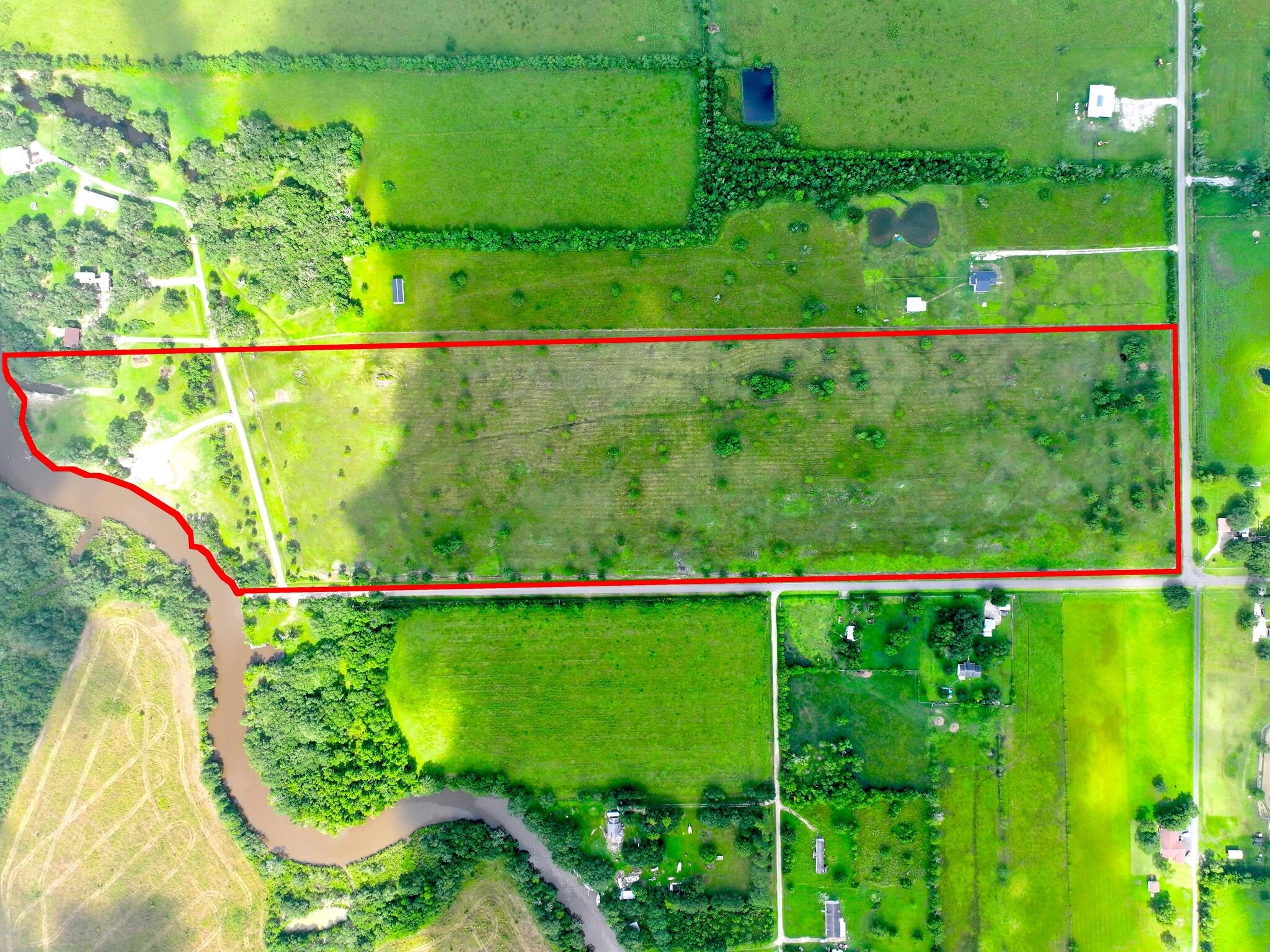 1734 Haynes Road Anahuac, TX 77514 - Photo 1 of 23 a view of a field with a tree in it