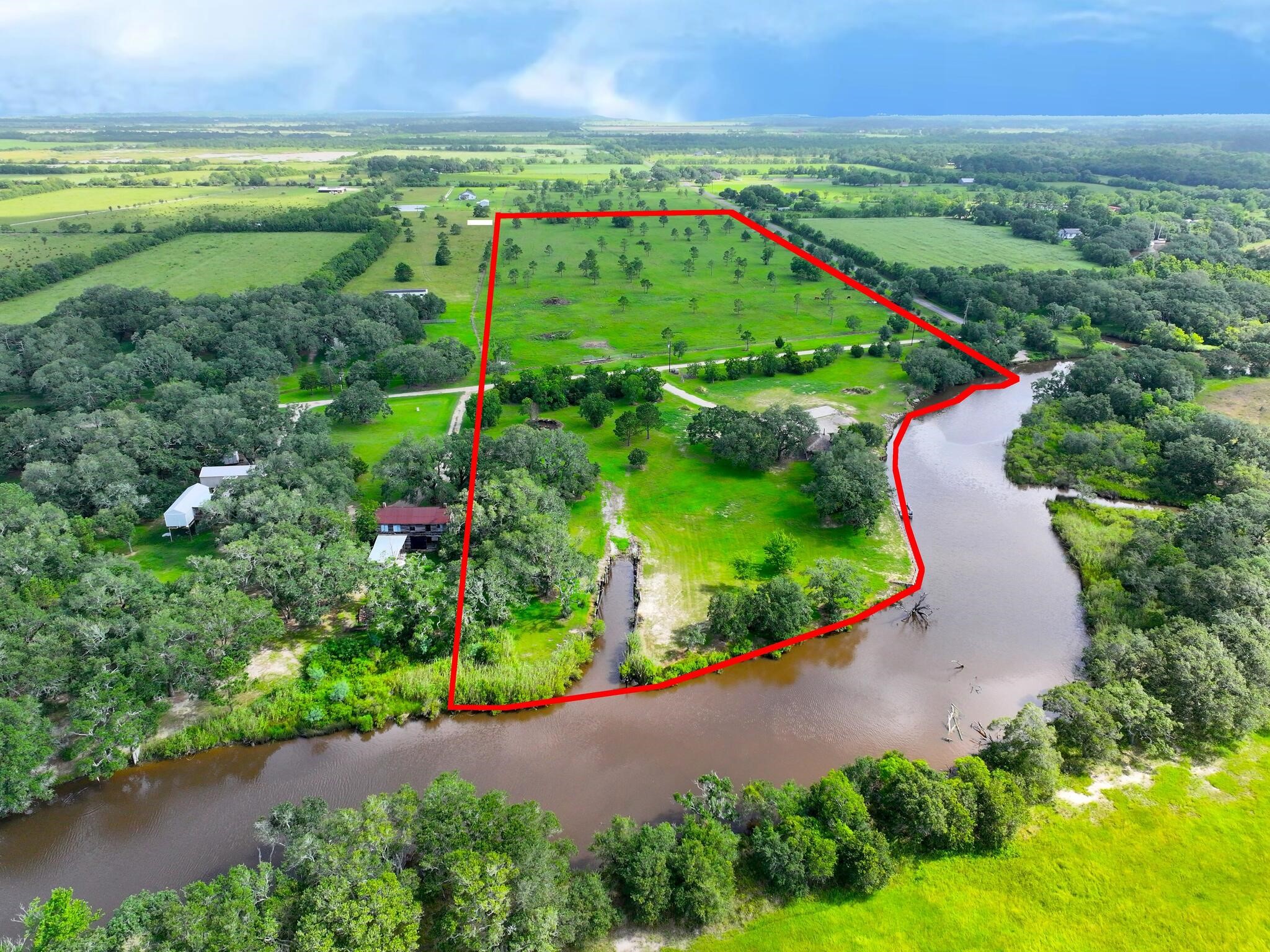 1734 Haynes Road Anahuac, TX 77514 - Photo 19 of 23 an aerial view of green landscape with trees and houses