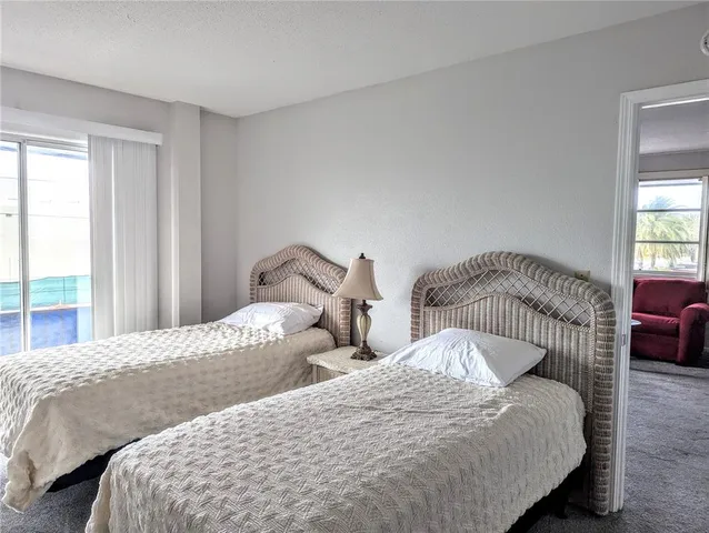 a bedroom with two beds and a window