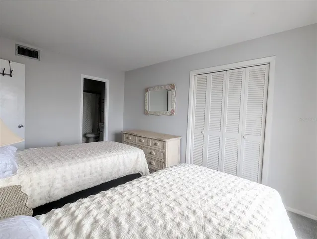 a bedroom with two beds and a window