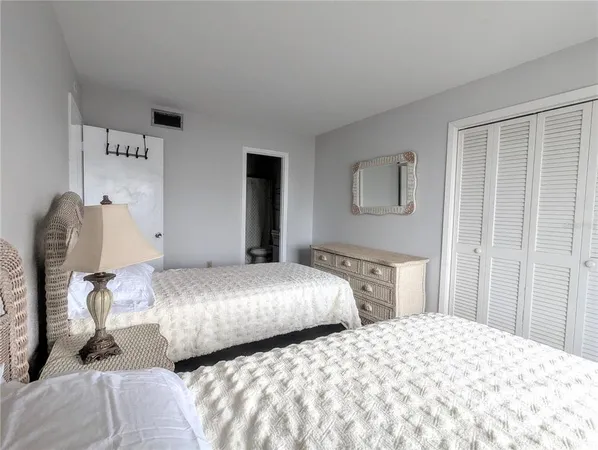 a bedroom with two beds and a window
