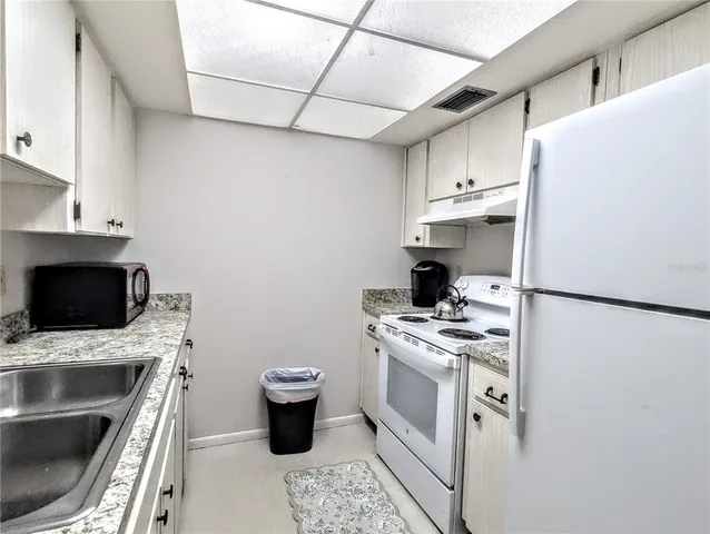 a kitchen with a stove and a refrigerator